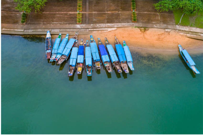 Aerial view Blue wooden boats wait tourists on the Con river in Phong Nha   Ke Bang, a UNESCO World Heritage Site in Quang Binh Province, Vietnam