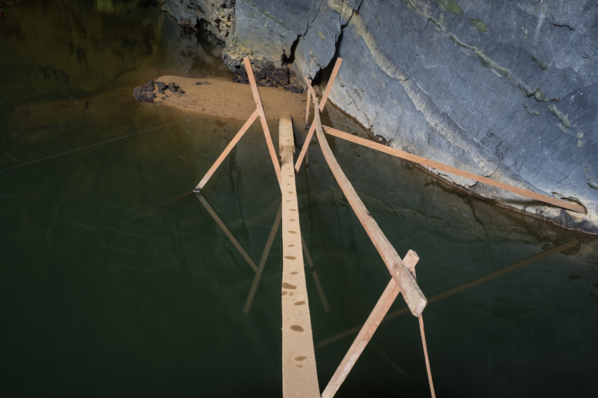 Small wooden bridge for walking into En Cave, the third largest cave in the world, is in the heart of the Phong Nha Ke Bang National Park in the Quang Binh province of Central Vietnam