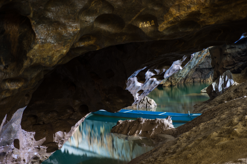 River and rock cliff, and rowing tourist boat inside of Phong Nha Cave in Phong Nha Ke Bang National Park, a UNESCO World Heritage Site in Quang Binh Province, Vietnam (3)